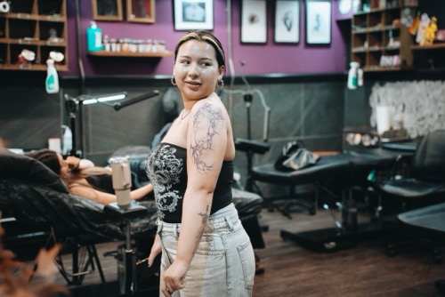 Happy customer showing off finished tattoo at Vivid Ink